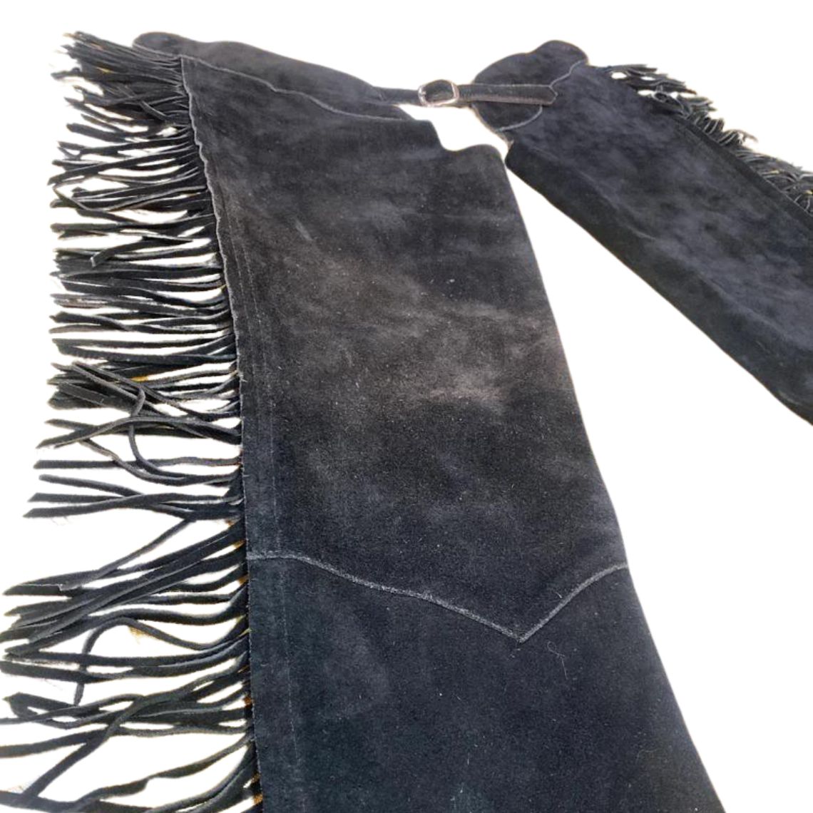 Close up of black suede fringe chaps detail