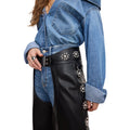 Close-up detail of women’s studded black leather biker chaps waist design