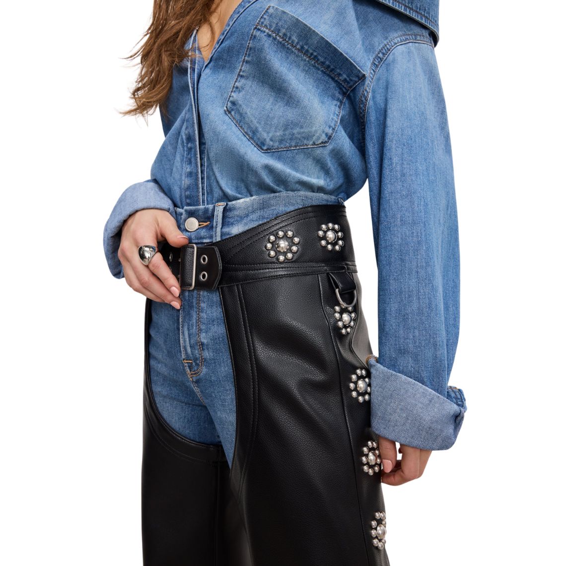 Close-up detail of women’s studded black leather biker chaps waist design