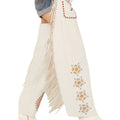 Side view of white leather chaps with fringe detailing