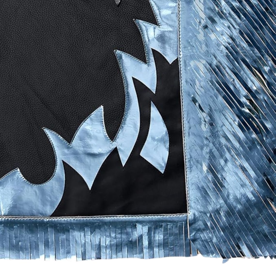 Close up of blue panel design and fringe on leather chaps