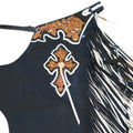 Close up of hand tooled western cross detail on black leather chaps