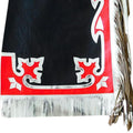 Bottom detail of red panel design with silver fringe on leather chaps
