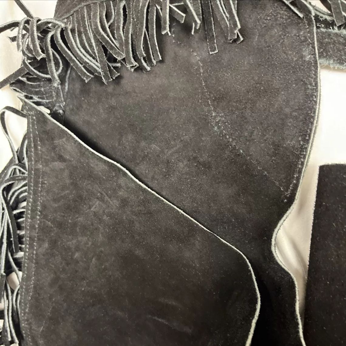 black leather fringe chaps side detail close-up