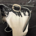 black suede chaps belt buckle close-up