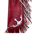 Close up of fringe and tooled panel on red rodeo chaps