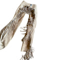 Close-up of fringe detailing on beige cowgirl chaps