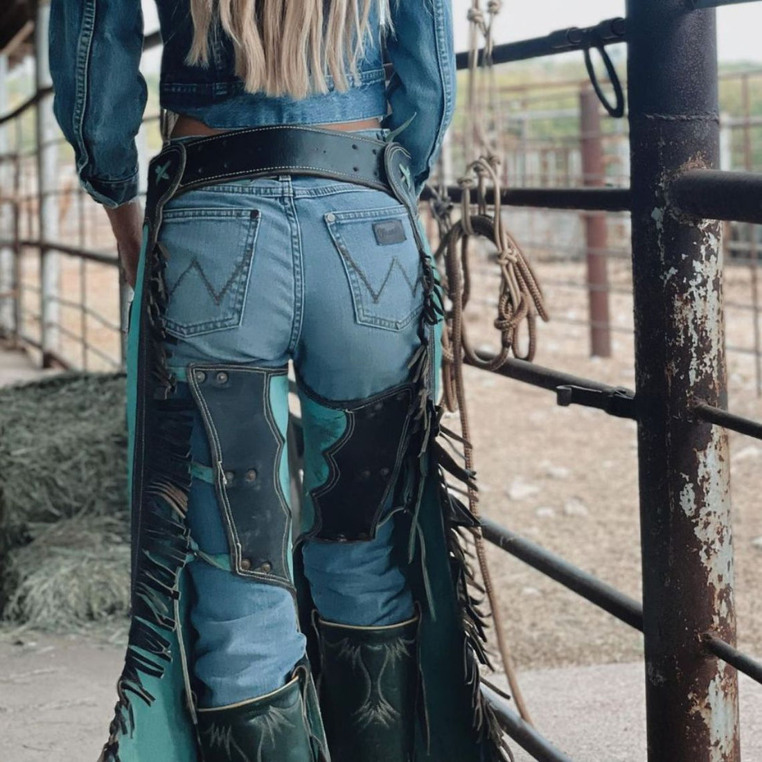 Women’s turquoise and black western chaps with heart patch front view